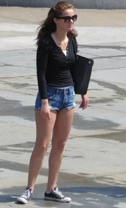 Cute girl with nice legs in short denim shorts