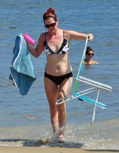 Tattooed redhead milf in a bikini at the beach