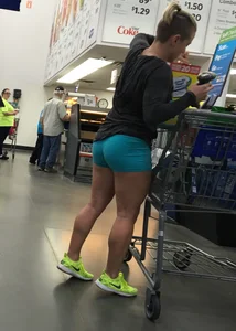 Big booty girl in blue spandex shorts shopping