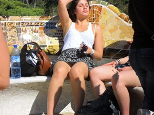 Girl in a skirt chilling on a bench