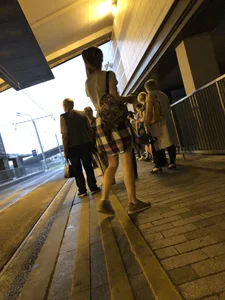 Cute Teen in Shorts on the Tram Stop