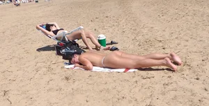 Girl laying out getting sun in a white thong bikini