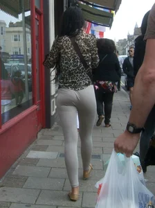Brunette lady with a nice ass in light grey leggings walking