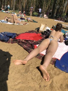 Girl in Swimsuit Lying on the Beach With Slightly Spread Legs