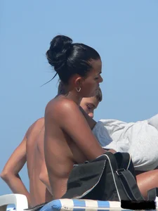 Hot ass topless beach girl with great tits lets her little brother oil up her ass in thong bikini