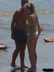 Sexy blonde on the beach in a yellow thong bikini