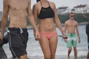 Peach bikini tattood babe on the beach with a nice ass and some camel toe