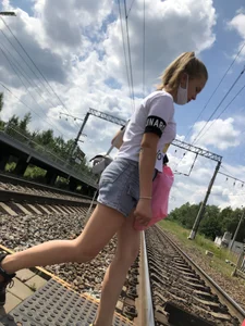 Cute Girl in Denim Shorts Walking Down a Railway Station Gallery