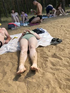 Girl in a Body Swimsuit Lying on Sand