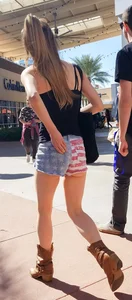 Cute girl with glasses in USA shorts showing her cheeks
