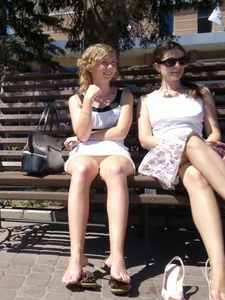 Young Girl Sitting on a Street Bench, Taken Off Her Sandals, and Flashing Panties Under Her Skirt
