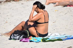 Thick mature brunette bikini lady on the beach with a nice body