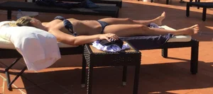 Blonde laying out in a blue bikini with a sexy body