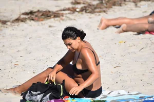 Thick mature brunette bikini lady on the beach with a nice body