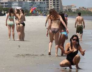 Brunette and redhead on the beach in bikinis looking sexy
