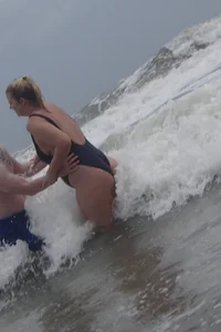 Thick blonde on the beach with a big booty in a blue swimsuit