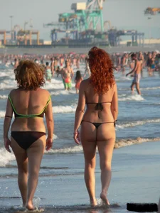 Bunch of sexy babes at the beach in thong bikinis