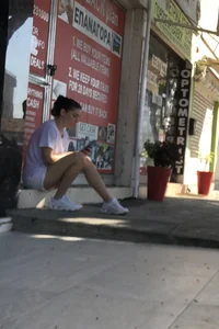 Cutie sitting on the street