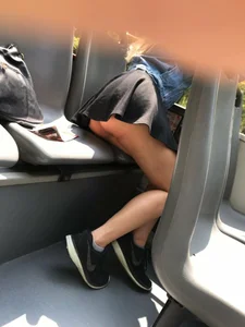 Skinny girl in a short skirt sitting in a bus and accidentally flashing her booty