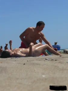 Purple thong topless lady on the beach gets oiled up by her husband