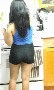Asian girlfriend doing dishes in spandex shorts