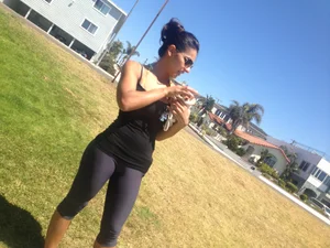 Hot brunette babe in leggings walking her dog with a nice ass and some cleavage