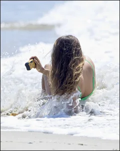 Super hot beach babe with a perfect body in a green thong bikini