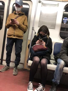Cute masked candid girl wearing a skirt and black pantyhose, subway train creepshots