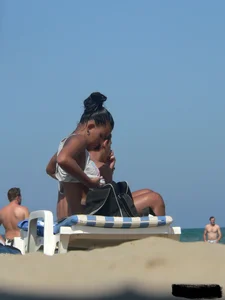 Hot ass topless beach girl with great tits lets her little brother oil up her ass in thong bikini