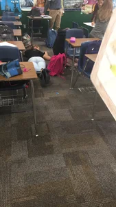 College Teen in Tight Jeans Planking on the Classroom Floor