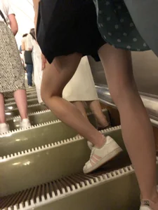 Slim legs closeup on a subway escalator creepshots