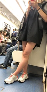 Blonde in a Dress and Sneakers With Sexy Skinny Legs in the Subway Train and on the Escalator Closeup Candid Photos