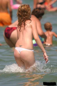 A bunch of sexy beach voyeur babes in bikinis, thongs and topless