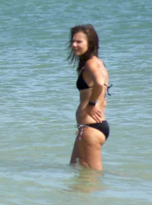 Older mature beach lady in a black bikini