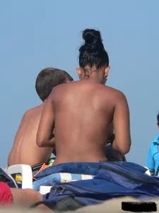Hot ass topless beach girl with great tits lets her little brother oil up her ass in thong bikini