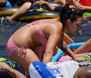 Sexy party girls in bikinis on a lake