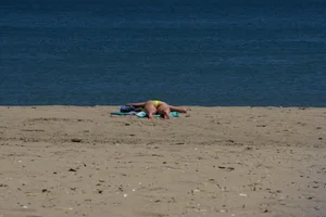 Sexy ass blonde milf on the beach in a thong with cameltoe and bending over