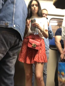 Hot candid subway chick wearing a skirt, sexy slim legs
