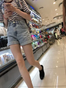 Girl in Blue Denim Shorts with Very Skinny Legs Store Candid