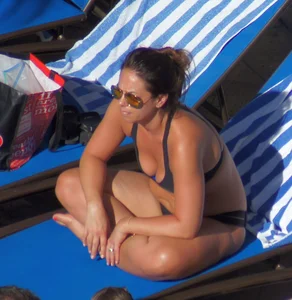Milf laying out in black bikini by the pool