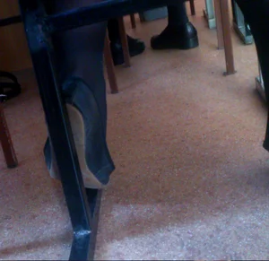 College Candid Teen’s Foot in Black Pantyhose and a Flat Under Desk Closeup Photo