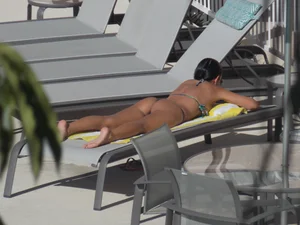 Hot milf sunbathing in a thong by pool and swimming