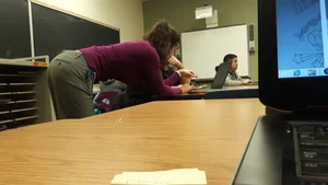 Sexy Teacher in Pants Bending Over the Desk Classroom Creepshot