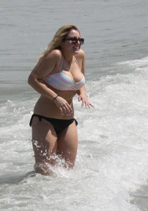 Big boobed thick blonde on the beach in a bikini