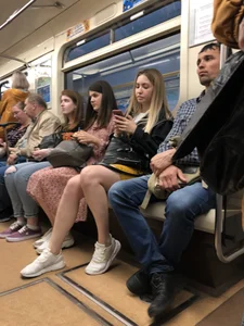 Cute candid girl with hot legs sitting in subway train