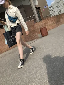 Cute candid teen with pale slim legs in shorts
