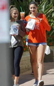 Brunette in tiny shorts walking with her sexy friend in leggings