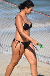 Thick mature brunette bikini lady on the beach with a nice body