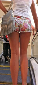 Girl in little floral shorts showing her cheeks