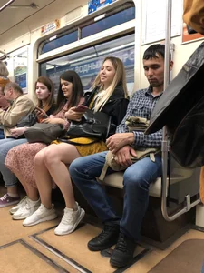 Cute candid girl with hot legs sitting in subway train